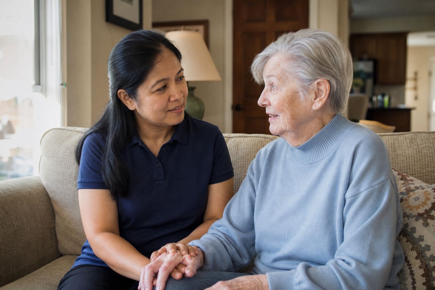 A caregiver sitting with an older adult at home